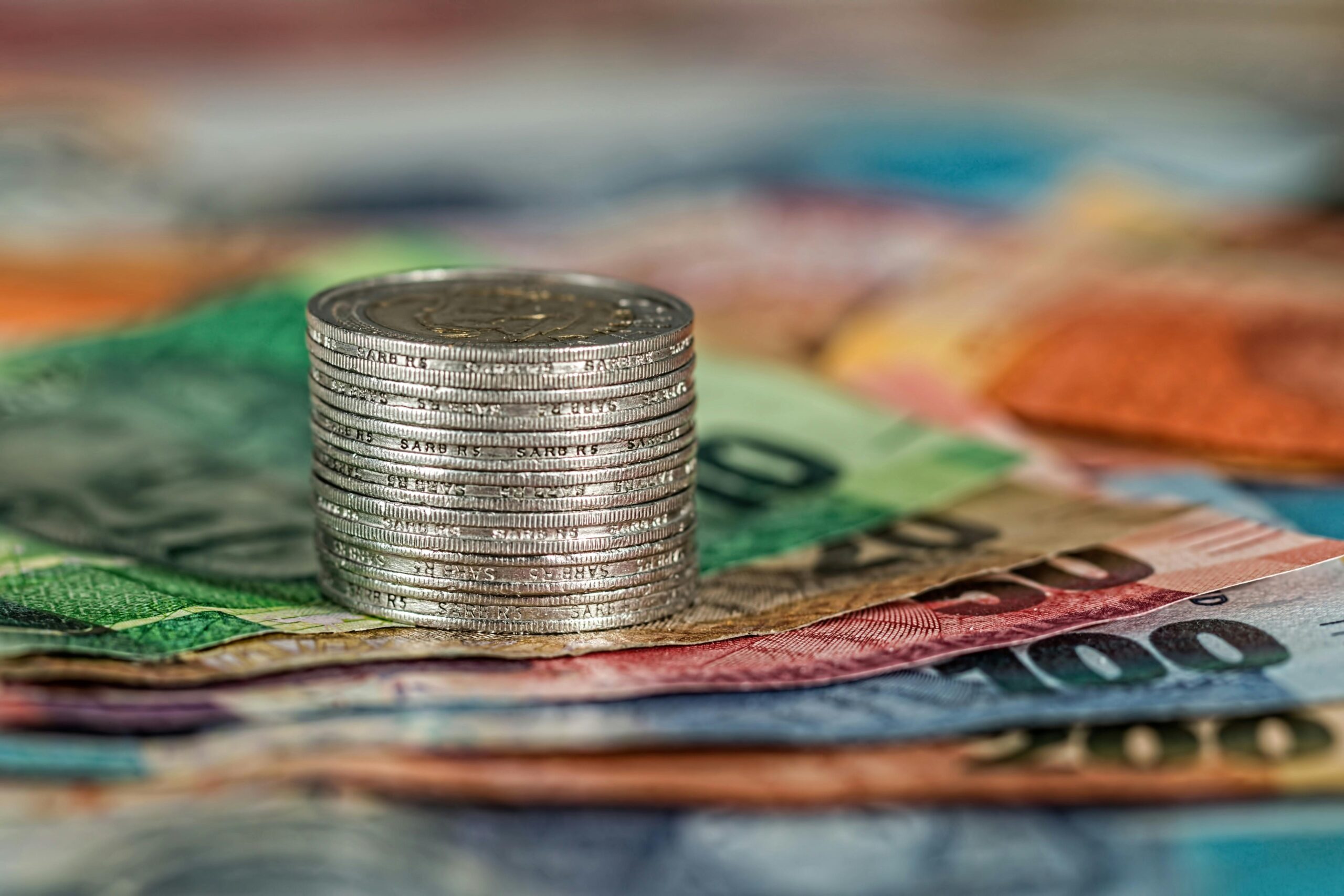 R5 coins stacked on top of South African Rand notes